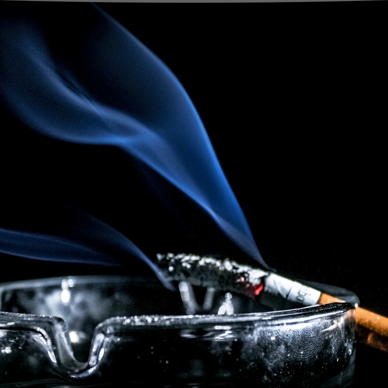 Image of a cigarette burning in an ashtray